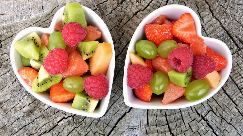 Two heart shaped dishes with fruit salad that represents the fruit of the Spirit
